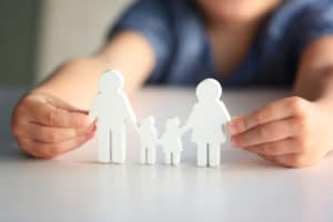 Child holding family cutout